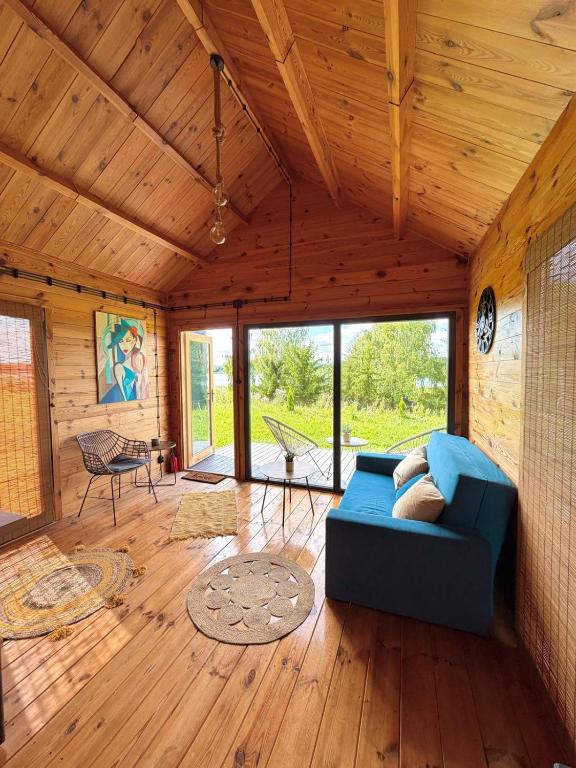 a living room with a blue couch in a house at Miły zakątek in Silice
