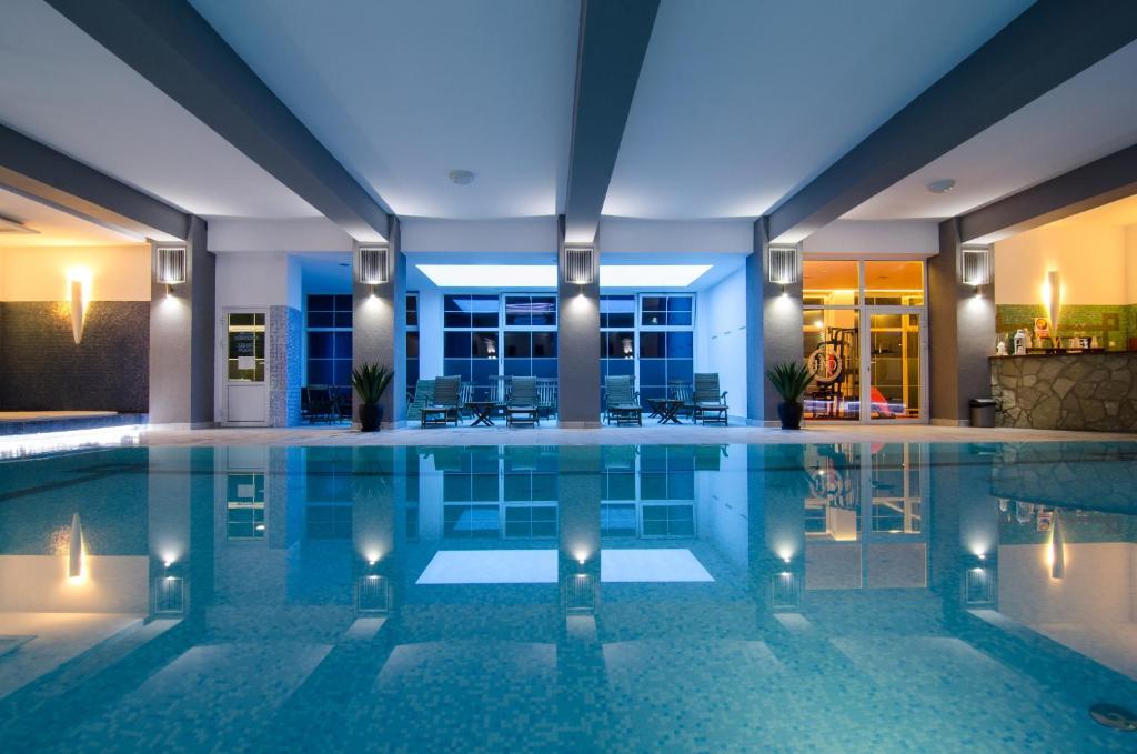 a swimming pool in a house with lights at Hotel Wellness & Spa Nowy Dwór in Rzeszów
