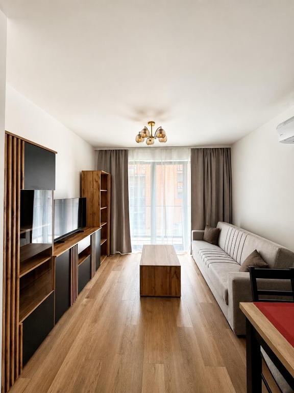 a living room with a couch and a table at Justinrent PALATIUM 31 in Legnica