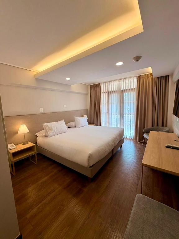 a bedroom with a large bed in a room at Hotel La Serena - Caja Los Andes in La Serena