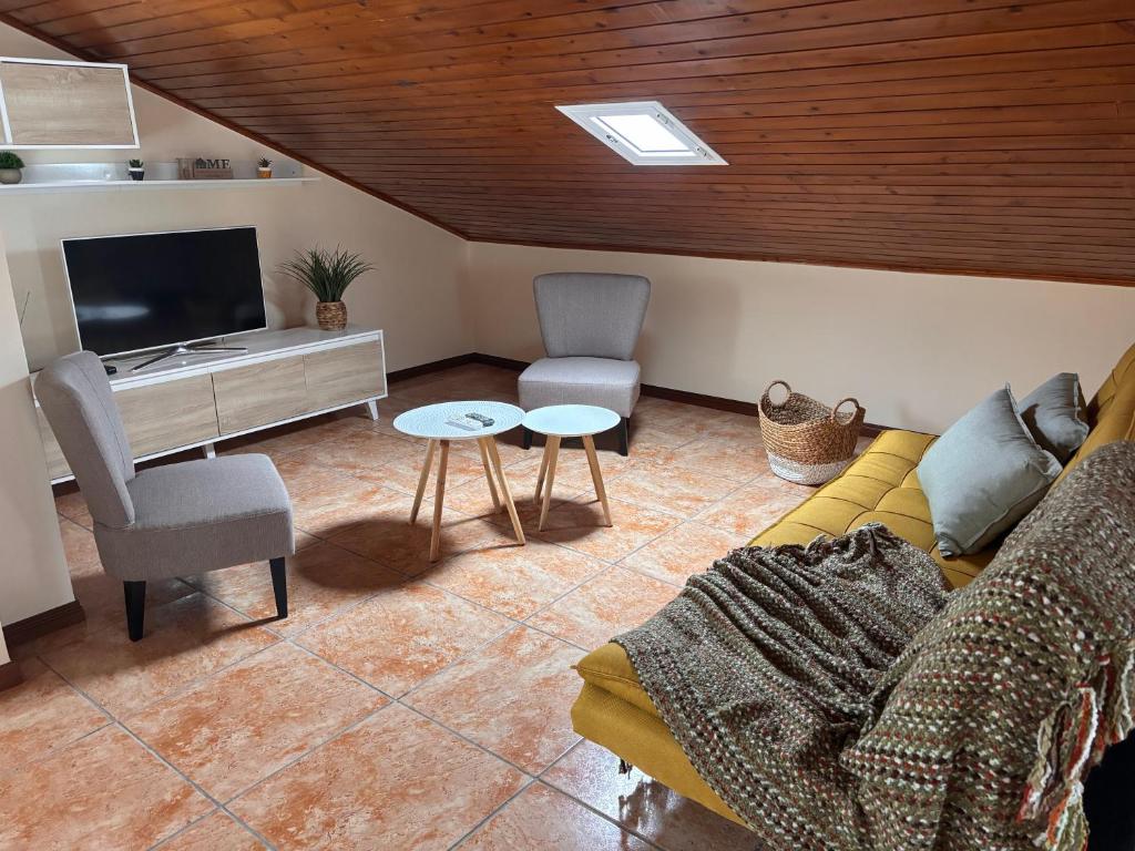 a living room with a couch and a tv at Tina's Place in Machico