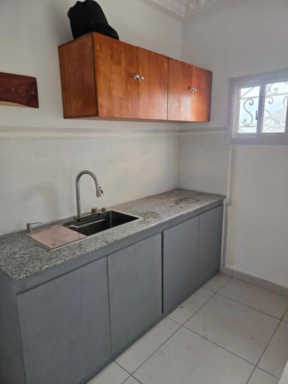 a kitchen with a sink and a counter top at Le gite 2 in Libreville