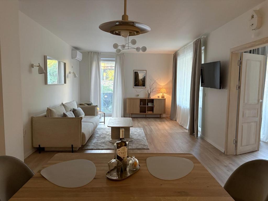 a living room with a couch and a table at Central Park View Apartment in Dobrich