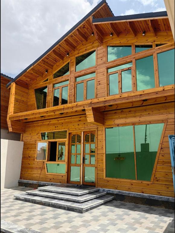 a wooden house with glass doors on it at اكواخ لاكجري ابها 2 in Abha