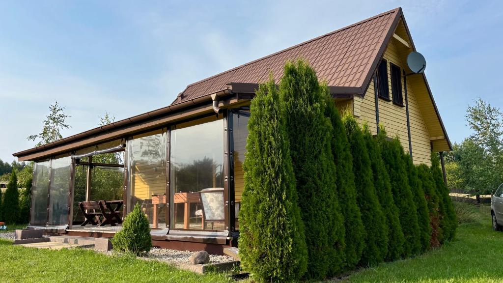 a house with glass windows and a roof at Ranczo Obozin 62 in Obozin