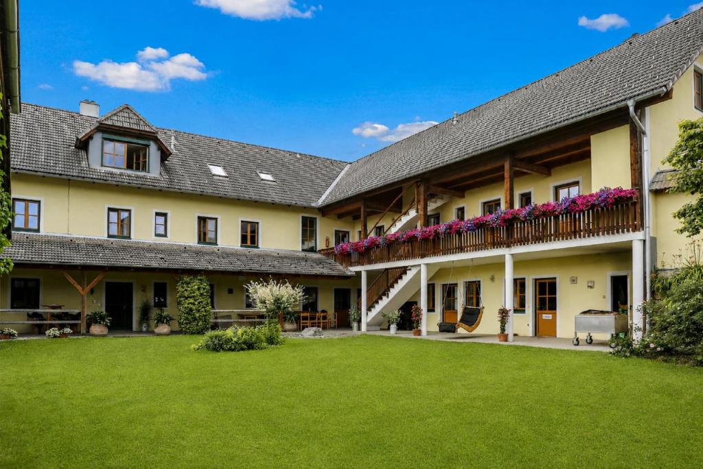 an exterior view of a house with a yard at Reitpark Gstöttner in Schönau im Mühlkreis