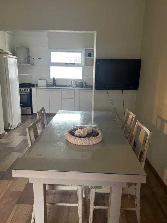 a table and chairs in a kitchen with a table at Coty A in Saladillo