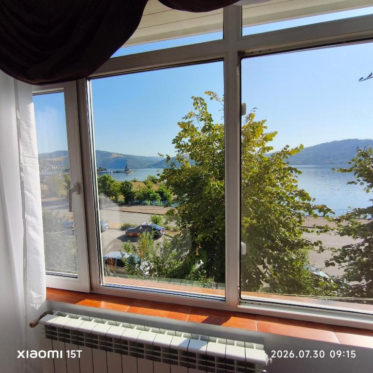 a large window with a view of the water at Apartament -BeaSarah-Orsova in Orşova