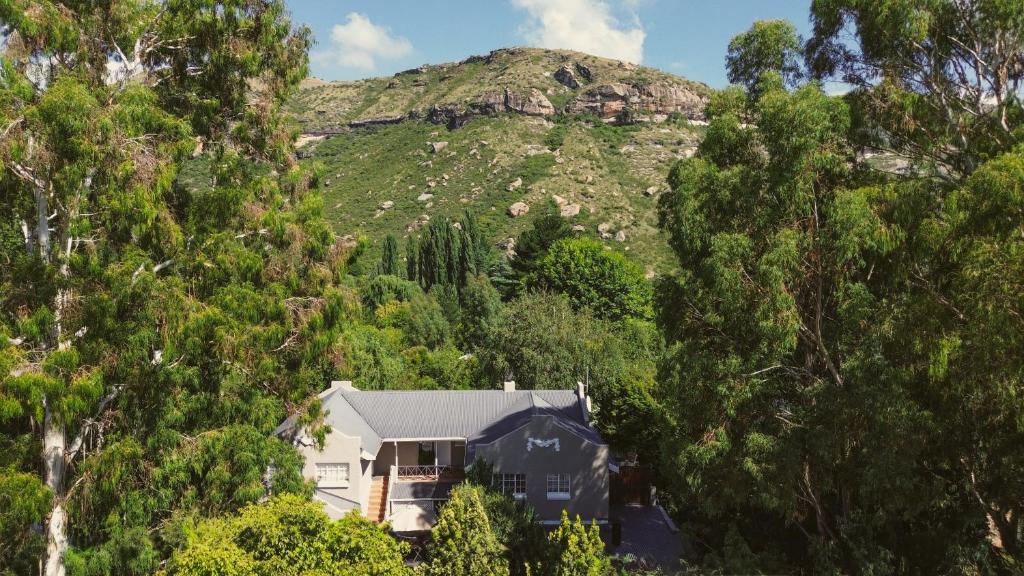 a house in the middle of a mountain at Patcham Place, Clarens in Clarens