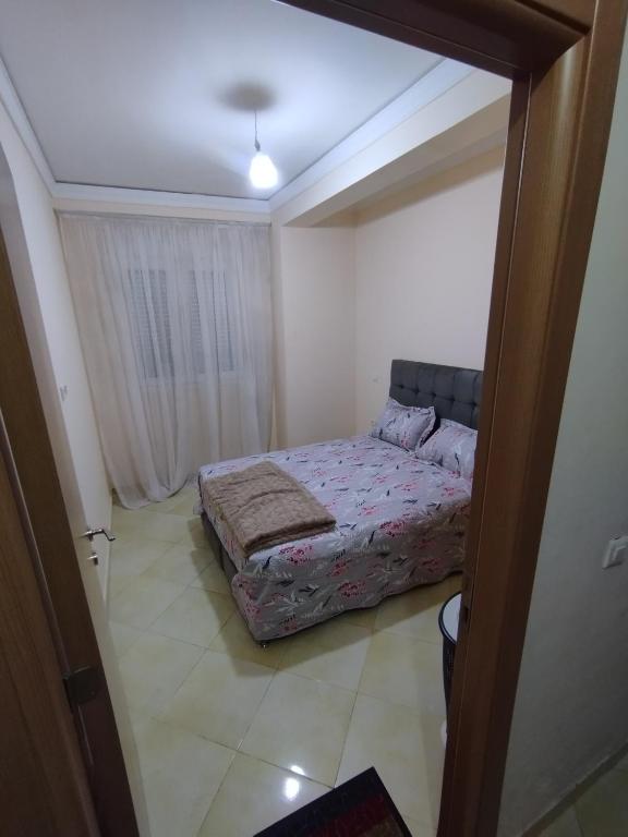 a bedroom with a bed in the middle of a room at Comp al Farah in Tangier