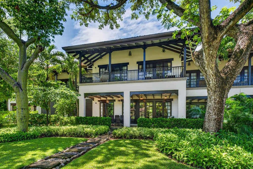 an exterior view of a house with trees at Resort Villa Pool Golf & Beach Access in Playa Avellana