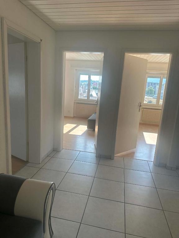 an empty living room with a view of a room at Apartament 2 Zimmer in Grenchen