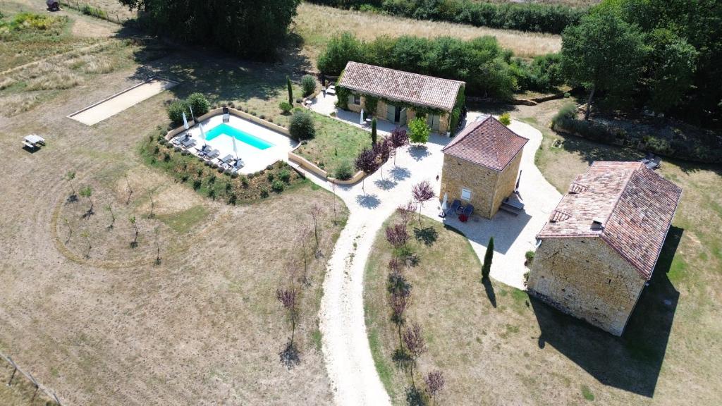 an aerial view of a house with a swimming pool at Le Bos Dordogne in Soulaures