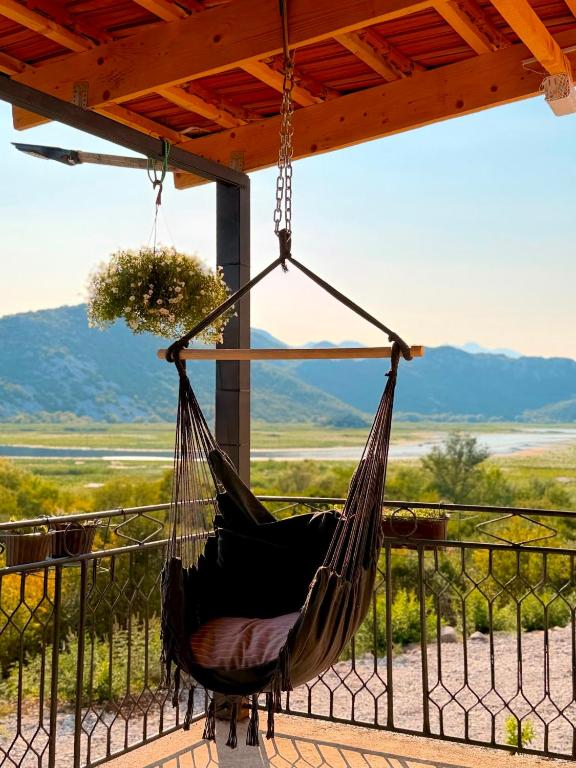 a hammock on a porch with a view at Water Lily Dock Prevlaka in Prevlaka