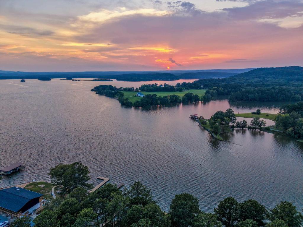 an island in the middle of a lake at sunset at Little River Marina in Cedar Bluff