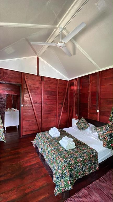 a hotel room with two beds and wooden walls at Conjá Ecolodge in Porto Alegre