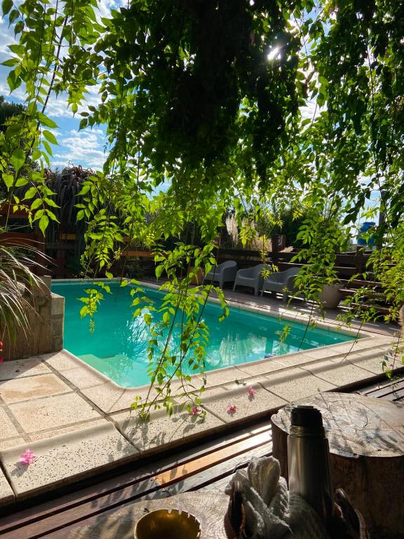 a swimming pool in front of a house at Talita Cumi in Villa Santa Cruz del Lago