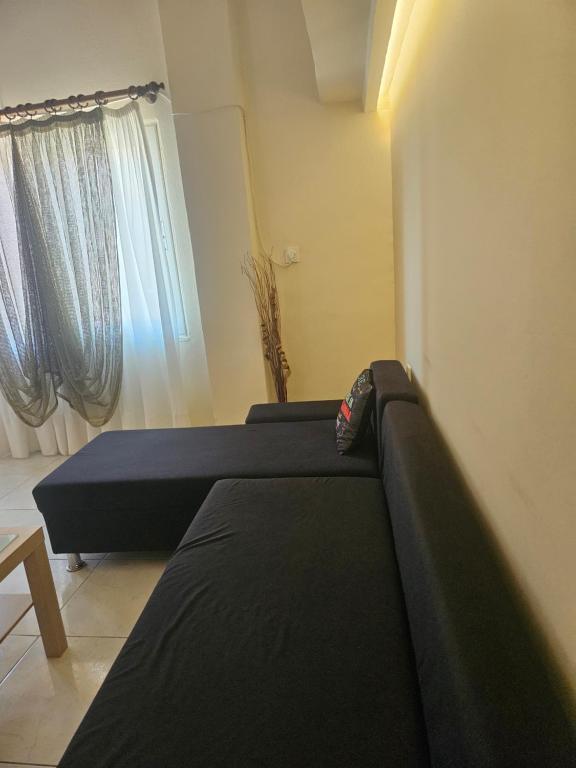 a bedroom with two beds in front of a window at Seven Plus in Filiatra