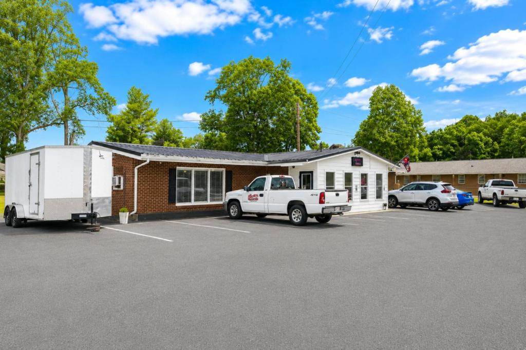 a building with a truck parked in a parking lot at Rocky Mount Motel near Hwy 220 in Rocky Mount