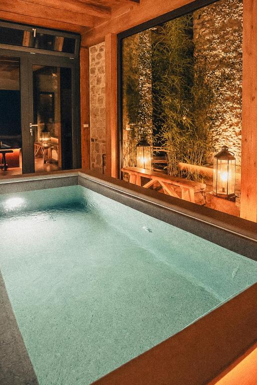 a swimming pool in a house with a patio at Ca' Bella Hospitality in Vignole Borbera