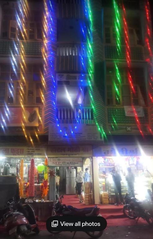 a building with colorful lights on it at night at Hotel motishree in Vidisha