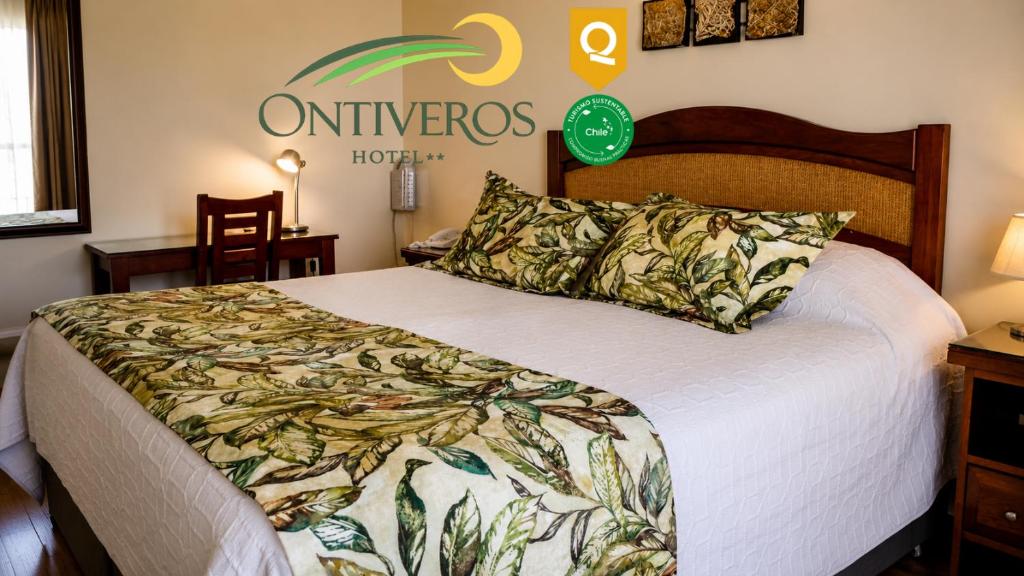 a hotel room with a bed and a sign on the wall at Hotel Ontiveros in San Fernando