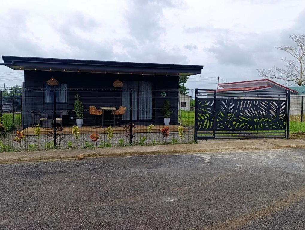 a black building with a bench in front of it at Alma Libre 01 in Fortuna