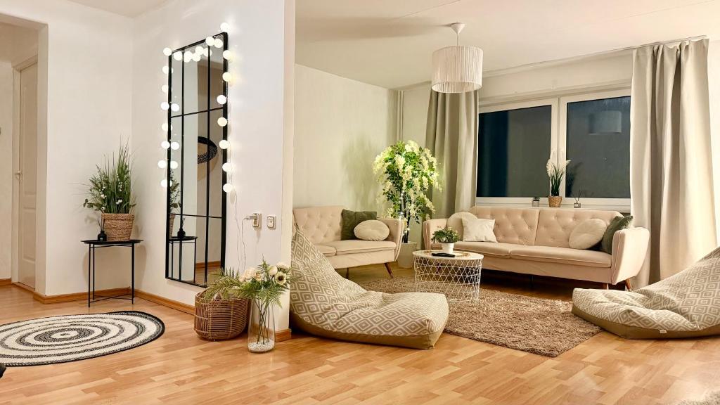 a living room with a couch and chairs at K&A apartament in Haapsalu