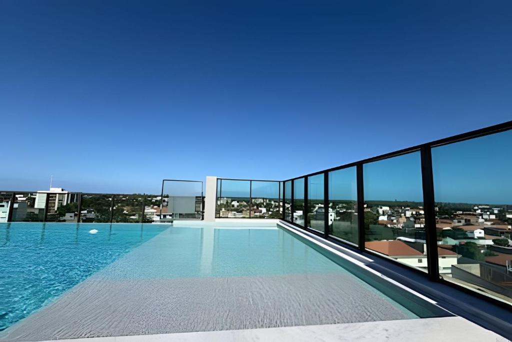 a swimming pool on the roof of a building at Flat 2/4 - Prestige 204 - Praia do Francês in Marechal Deodoro