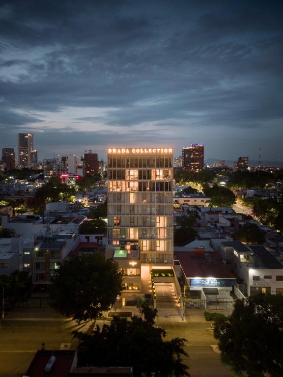 a lit up building in a city at night at Brada Collection Vendôme in Guadalajara