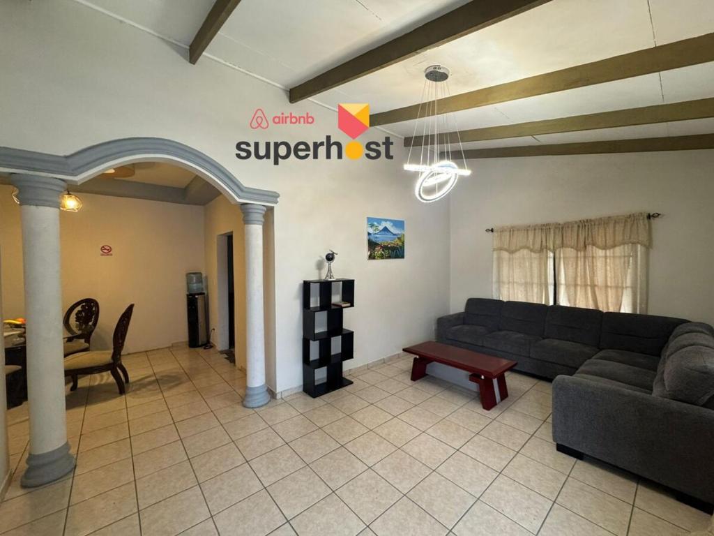 a living room with a couch and a table at Luxurious Platinum House 3VX in San Pedro Sula