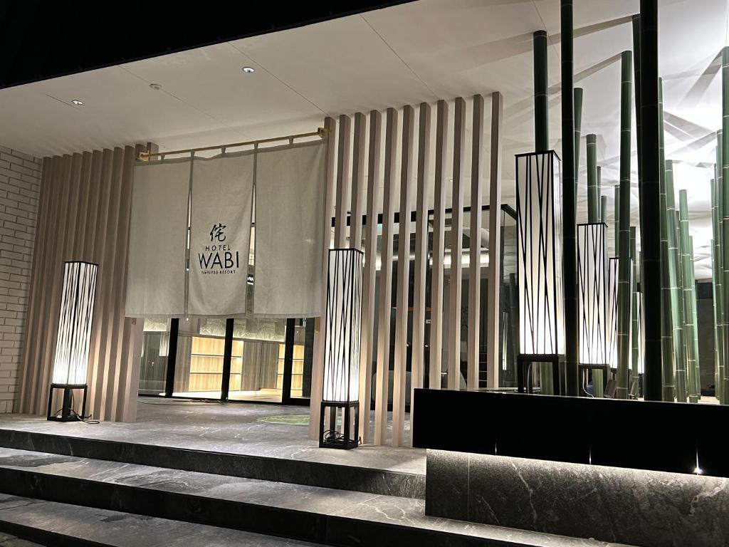 a lobby of a building with stairs and lights at ホテル侘 in Himeji