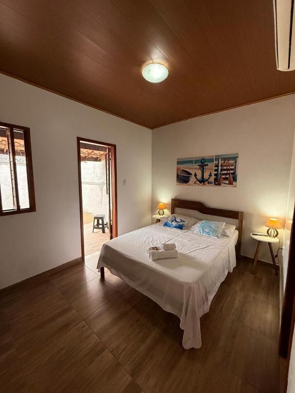 a bedroom with a large white bed in a room at Studio Praia do Chapéu in Mata de Sao Joao