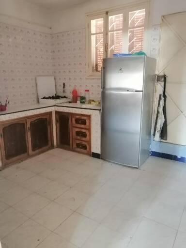 a kitchen with a stainless steel refrigerator in it at Akr appartement in Al Hoceïma