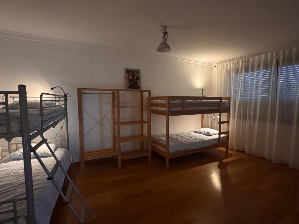 a room with two bunk beds and a window at Valença RoofTop by Beeflats BnB in Valença