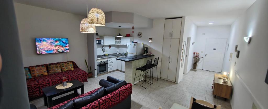 a living room with a couch and a kitchen at Nuestra Recova 2 en Pilar BsAs in Pilar