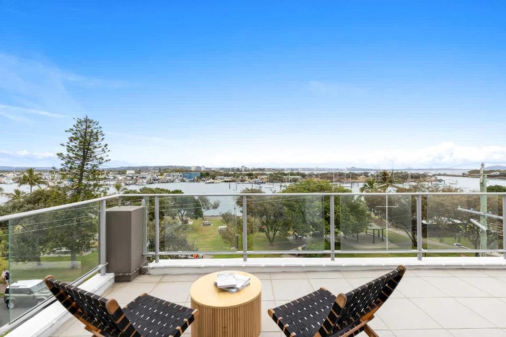 a balcony with chairs and a view of the water at Point Cartwright Penthouse - Ocean and River Views in Buddina