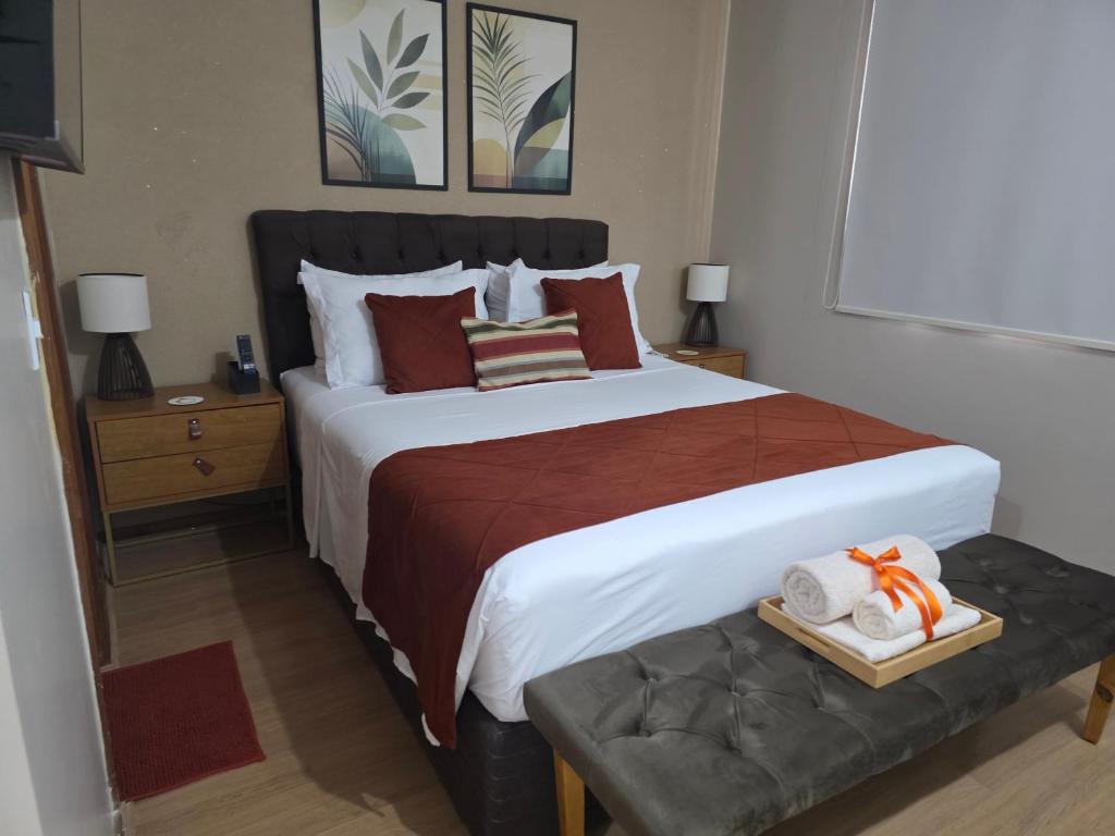 a bedroom with a large bed with towels on it at Studio Sudoeste Ed Multiparque in Brasília