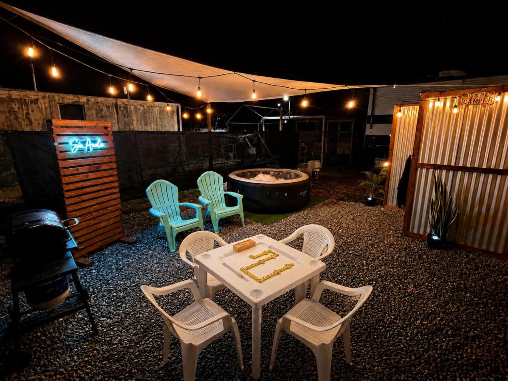 a patio with a table and chairs and a tub at Sin Ancla in Boqueron