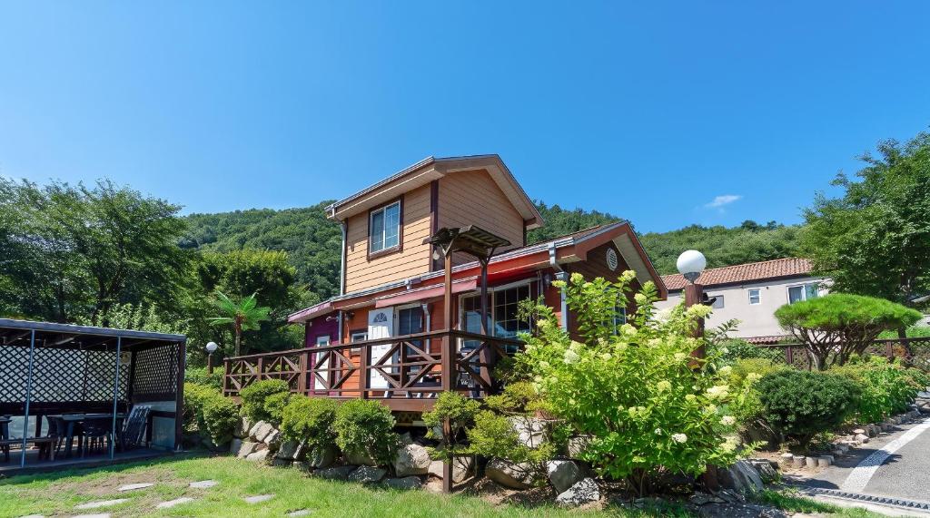 a house on a hill with trees and bushes at Yangpyeong Narinsoom Private Villa in Yangpyeong