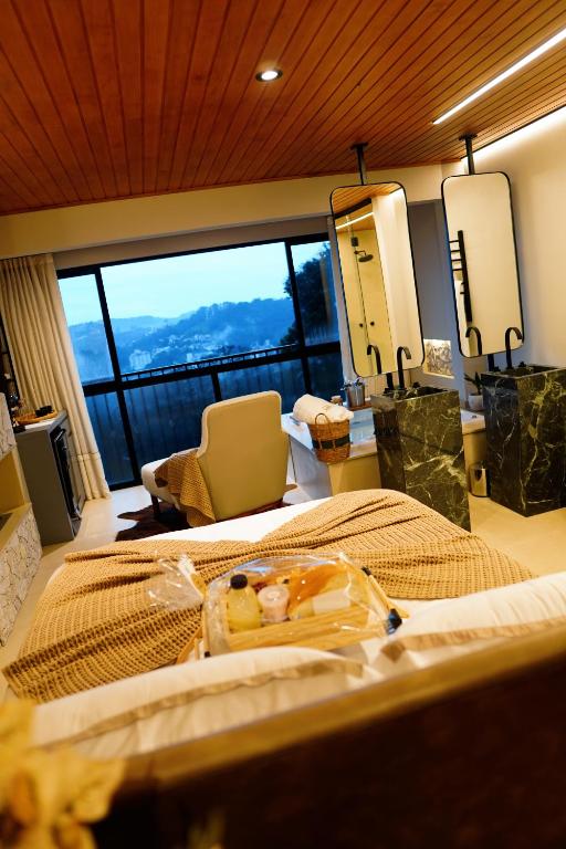 a bedroom with a large bed and a large window at Moldavite Bungalow in Treze Tílias