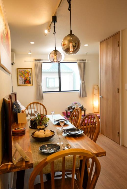 a dining room with a table with chairs and a dining room at 和モダン福 名古屋駅徒歩8分 最大10名 一軒家貸切 寝室3 in Minami-sotoborichō