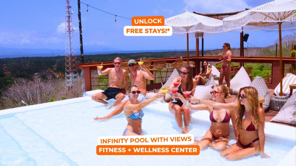 a group of people sitting in a swimming pool at Mad Monkey Nusa Lembongan in Nusa Lembongan