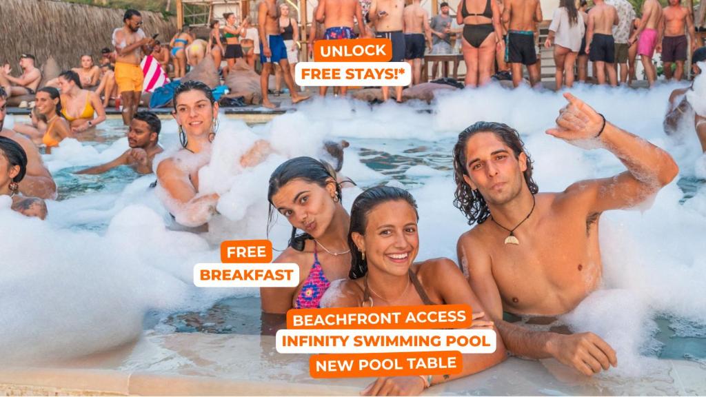 a group of people in a hot tub with smokes at Mad Monkey Gili Trawangan in Gili Trawangan