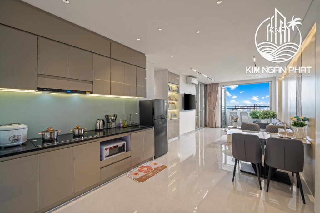 a kitchen with a table and a dining room at Kim Ngan Phat Deluxe Apartment in Danang