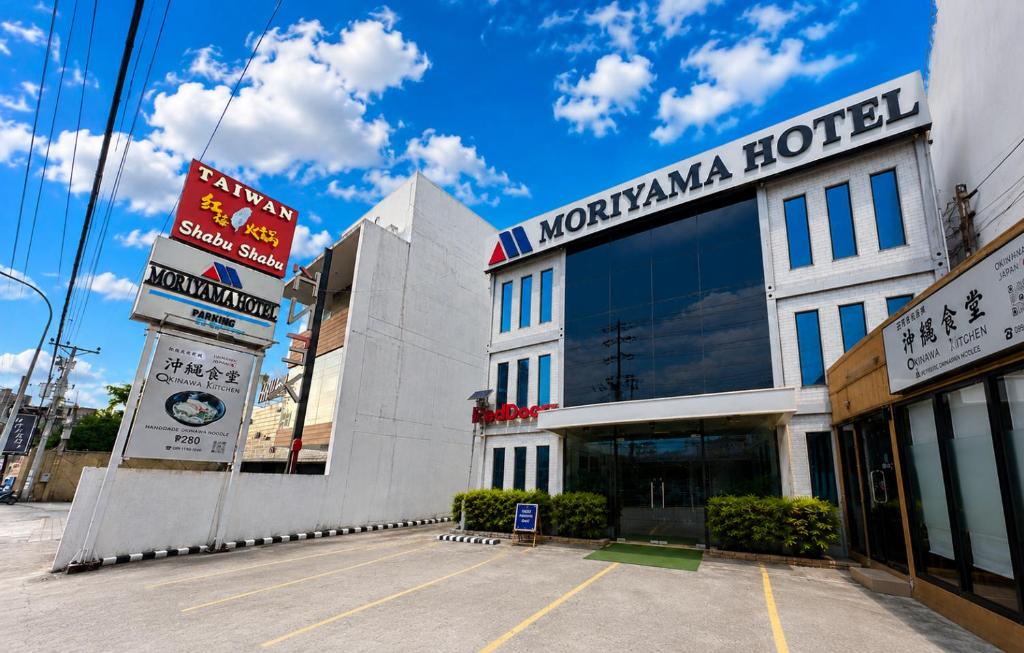 a building with a sign for a hotel at Moriyama Hotel in Mandaue City