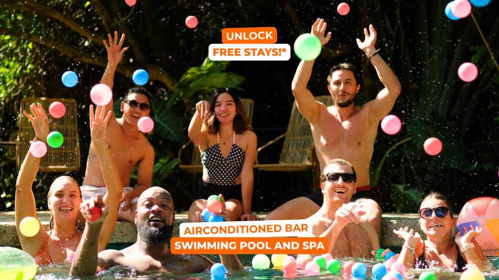 a group of people in the water playing with balls at Mad Monkey Dumaguete in Dumaguete