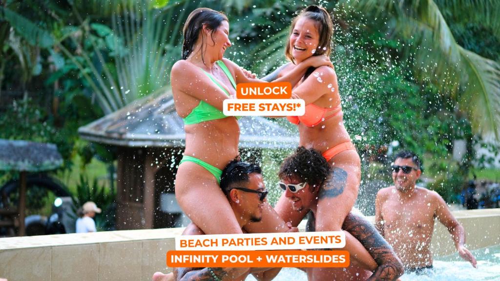 two women in bathing suits standing in a swimming pool at Mad Monkey Siquijor in Siquijor