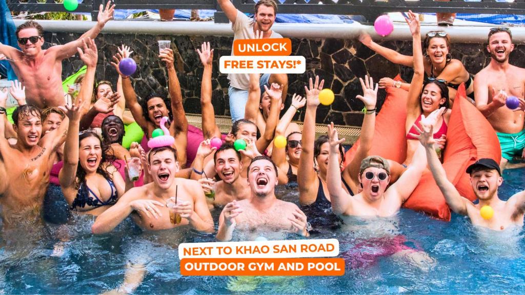 a group of people in the water at a swimming pool at Mad Monkey Bangkok in Bangkok