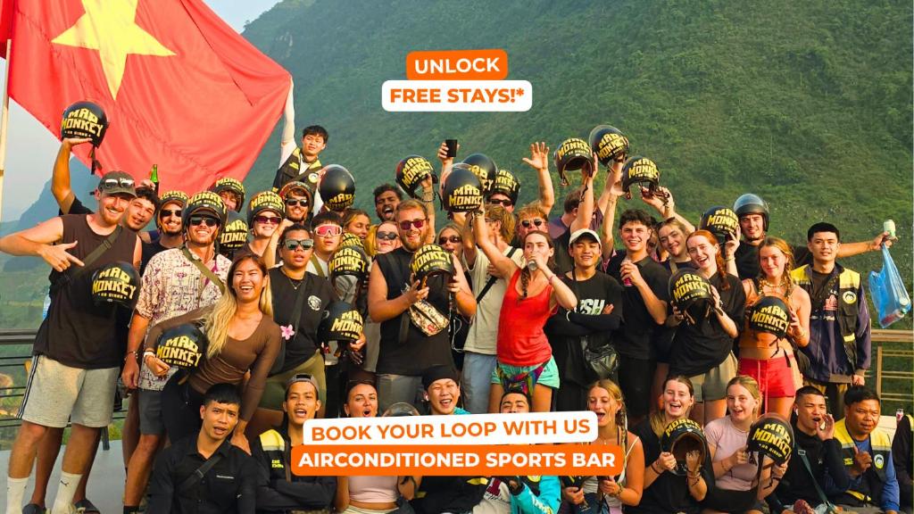 a group of people are posing for a picture at Mad Monkey Hanoi Hostel in Hanoi